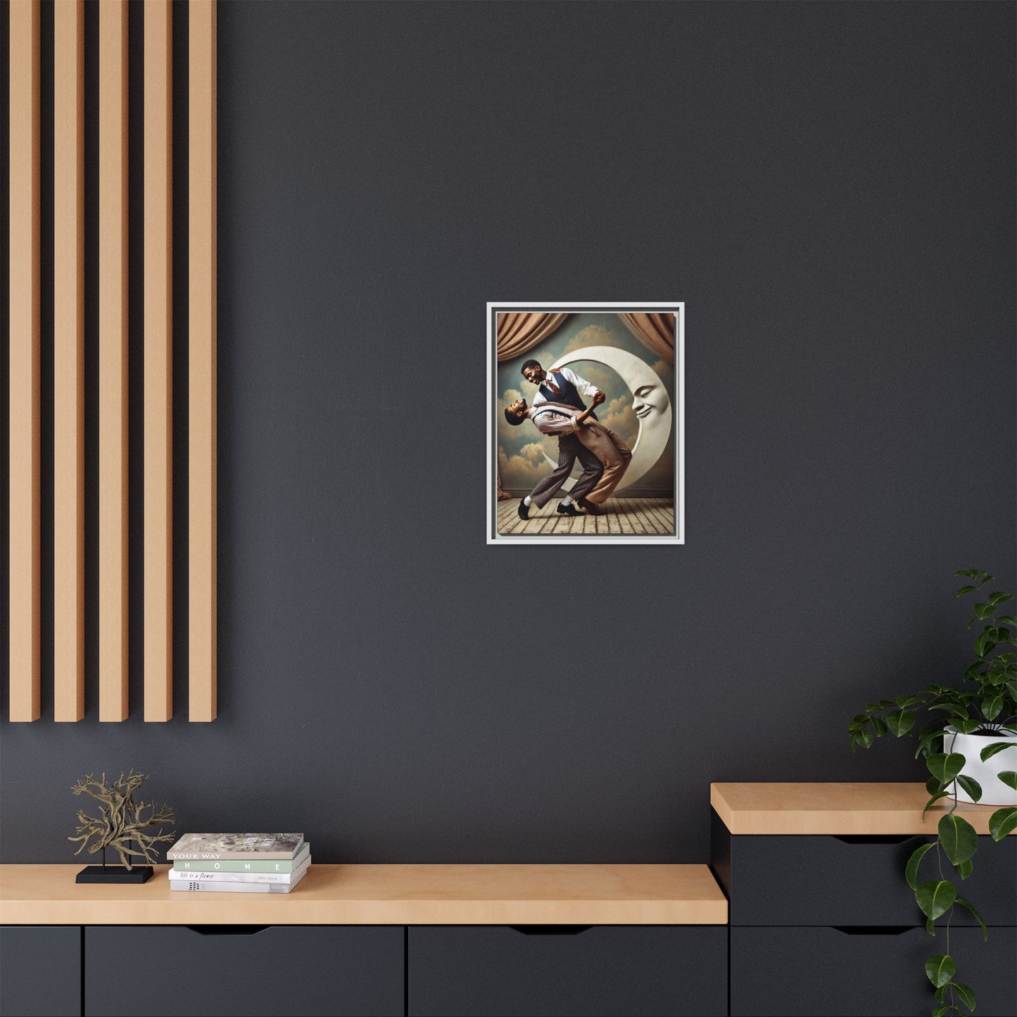Framed artwork of two Black men in vintage suits dancing tenderly beneath a crescent moon with a smiling face. A romantic 1920s-inspired scene with velvet curtains and a painted sky backdrop. Part of a collection reclaiming lost queer Black history and art.