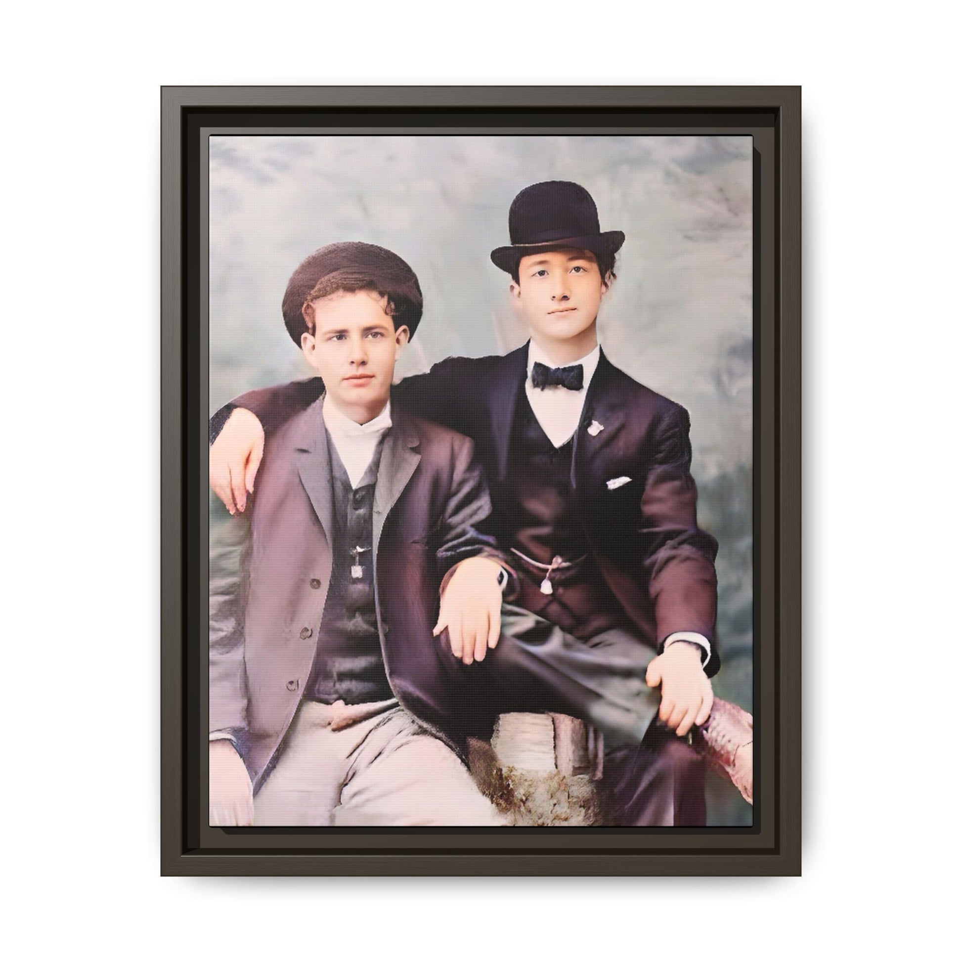A stunningly restored early 20th-century portrait of Francis and Fai in Santa Barbara, California. Dressed in elegant bowler hats and classic suits, the two men share a poised yet deeply connected moment. The soft pastel tones and refined attire highlight a timeless love story, celebrating LGBTQ+ history and authentic companionship. Gay Couple