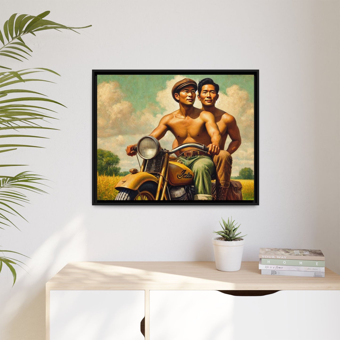 Framed artwork of an Asian-American gay couple riding a vintage yellow motorcycle through Iowa's serene countryside, celebrating love and unity.
