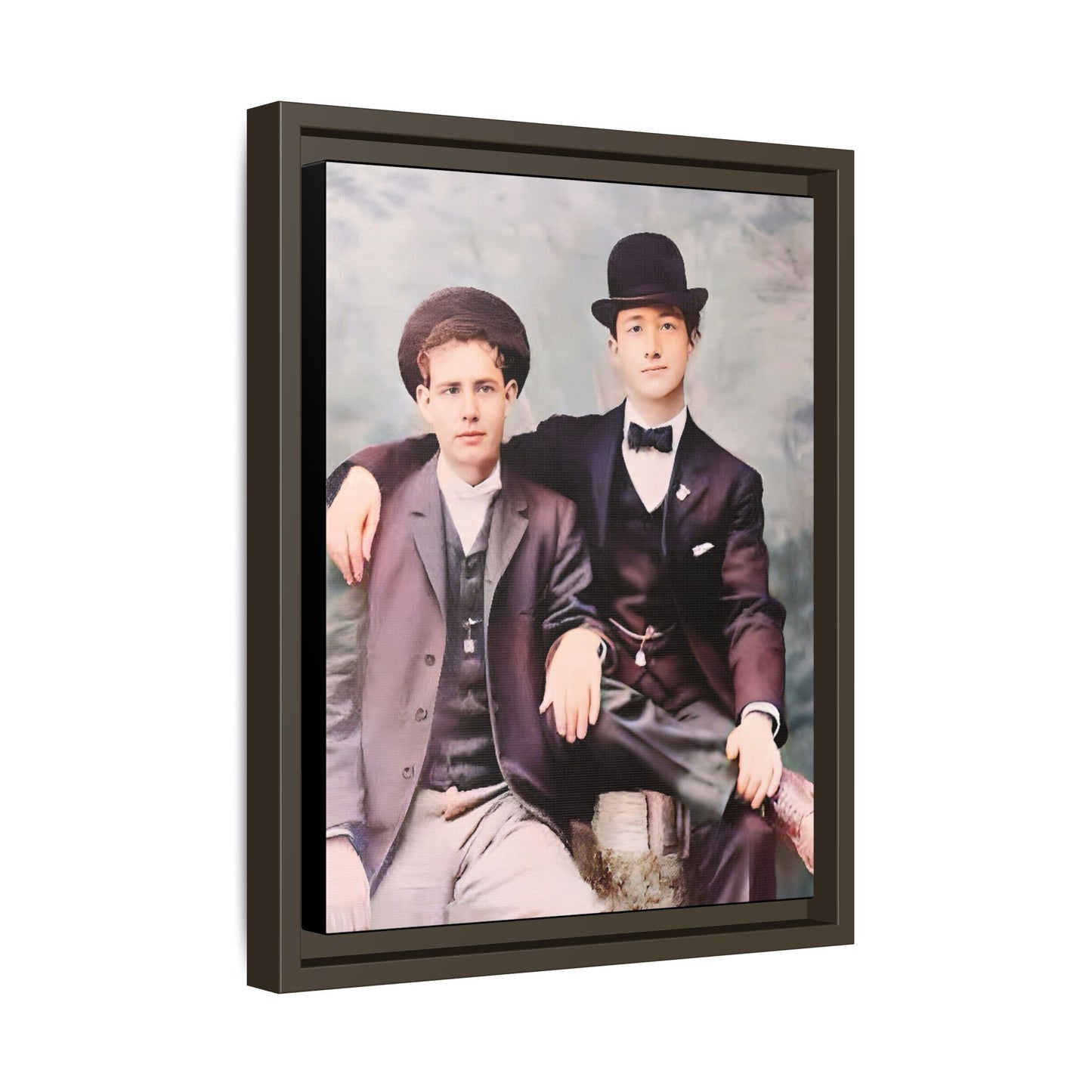 A stunningly restored early 20th-century portrait of Francis and Fai in Santa Barbara, California. Dressed in elegant bowler hats and classic suits, the two men share a poised yet deeply connected moment. The soft pastel tones and refined attire highlight a timeless love story, celebrating LGBTQ+ history and authentic companionship. Gay Couple