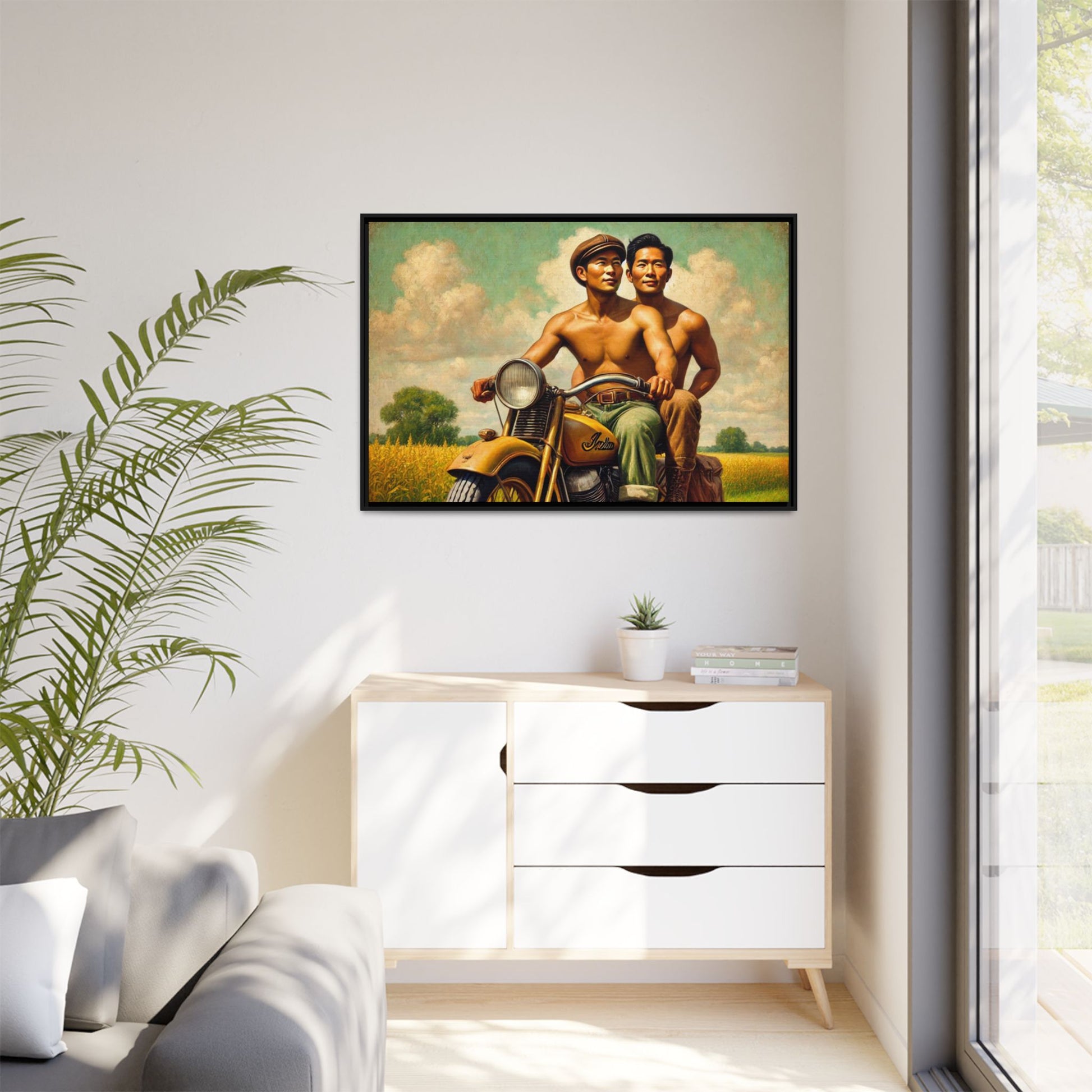 Framed artwork of an Asian-American gay couple riding a vintage yellow motorcycle through Iowa's serene countryside, celebrating love and unity.