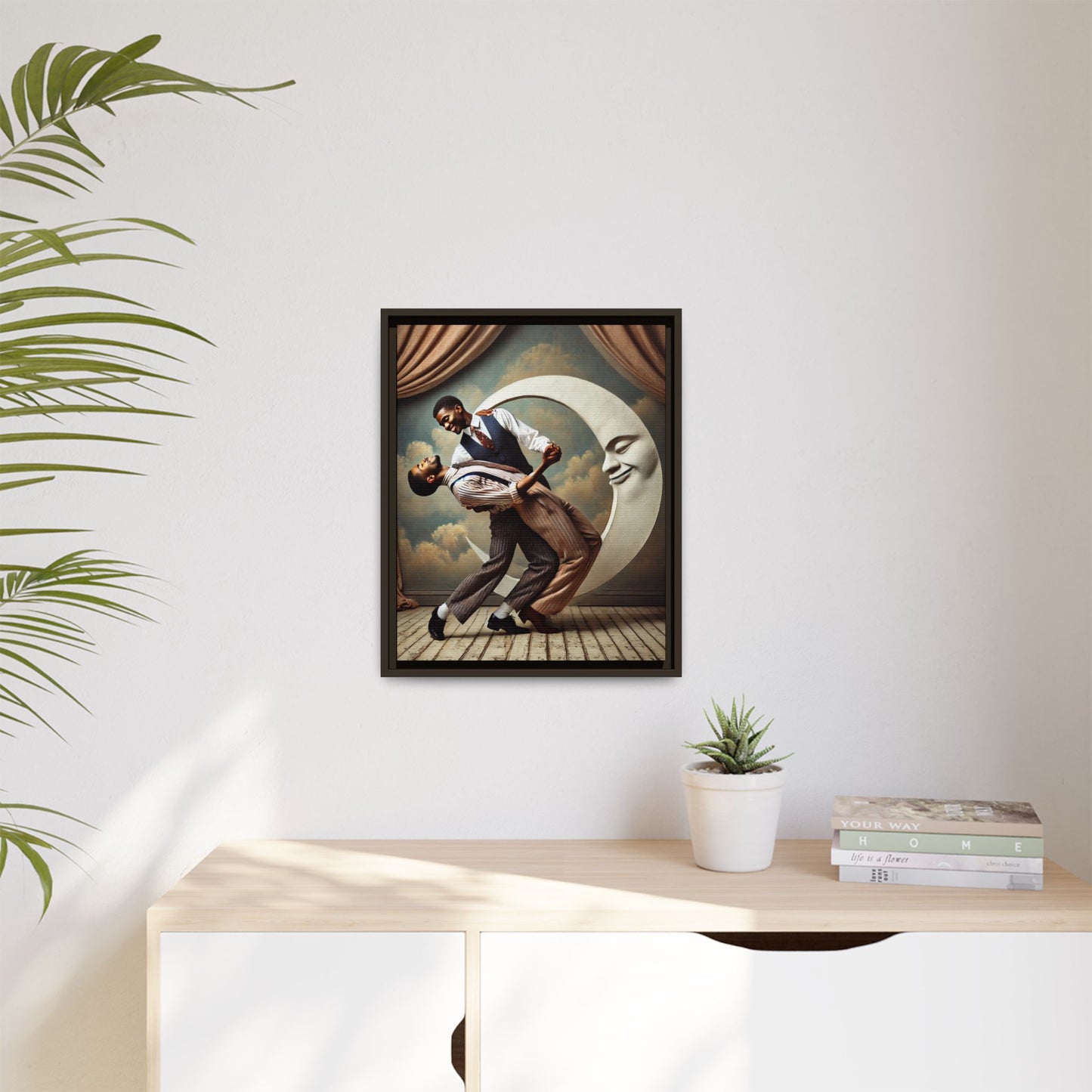 Framed artwork of two Black men in vintage suits dancing tenderly beneath a crescent moon with a smiling face. A romantic 1920s-inspired scene with velvet curtains and a painted sky backdrop. Part of a collection reclaiming lost queer Black history and art.