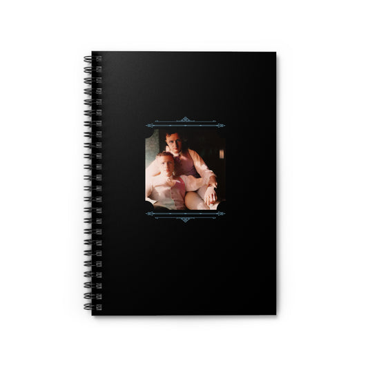 Colorized vintage LGBTQ photo of two men in a tender embrace on a matte black spiral notebook cover
