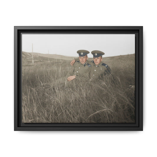 Early 20th century outdoor portrait of two uniformed men seated together in tall grass