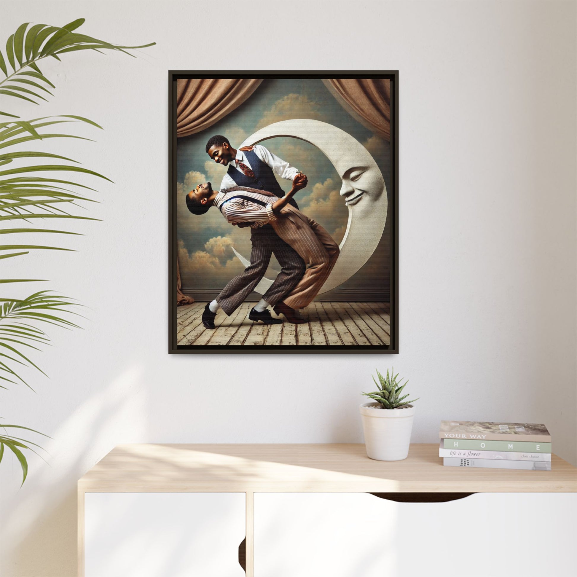 Framed artwork of two Black men in vintage suits dancing tenderly beneath a crescent moon with a smiling face. A romantic 1920s-inspired scene with velvet curtains and a painted sky backdrop. Part of a collection reclaiming lost queer Black history and art.