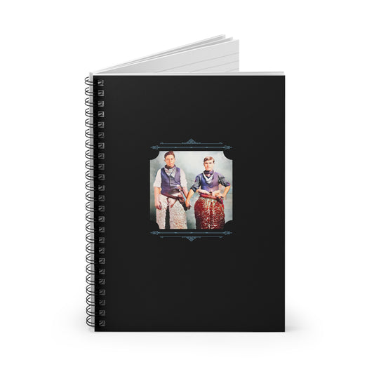 Restored early 1900s photo of two men in cowboy attire holding hands on a black spiral notebook