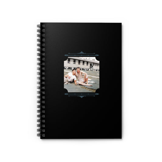 Spiral notebook with a restored vintage WWII photo of three men relaxing on an army base, one African American.