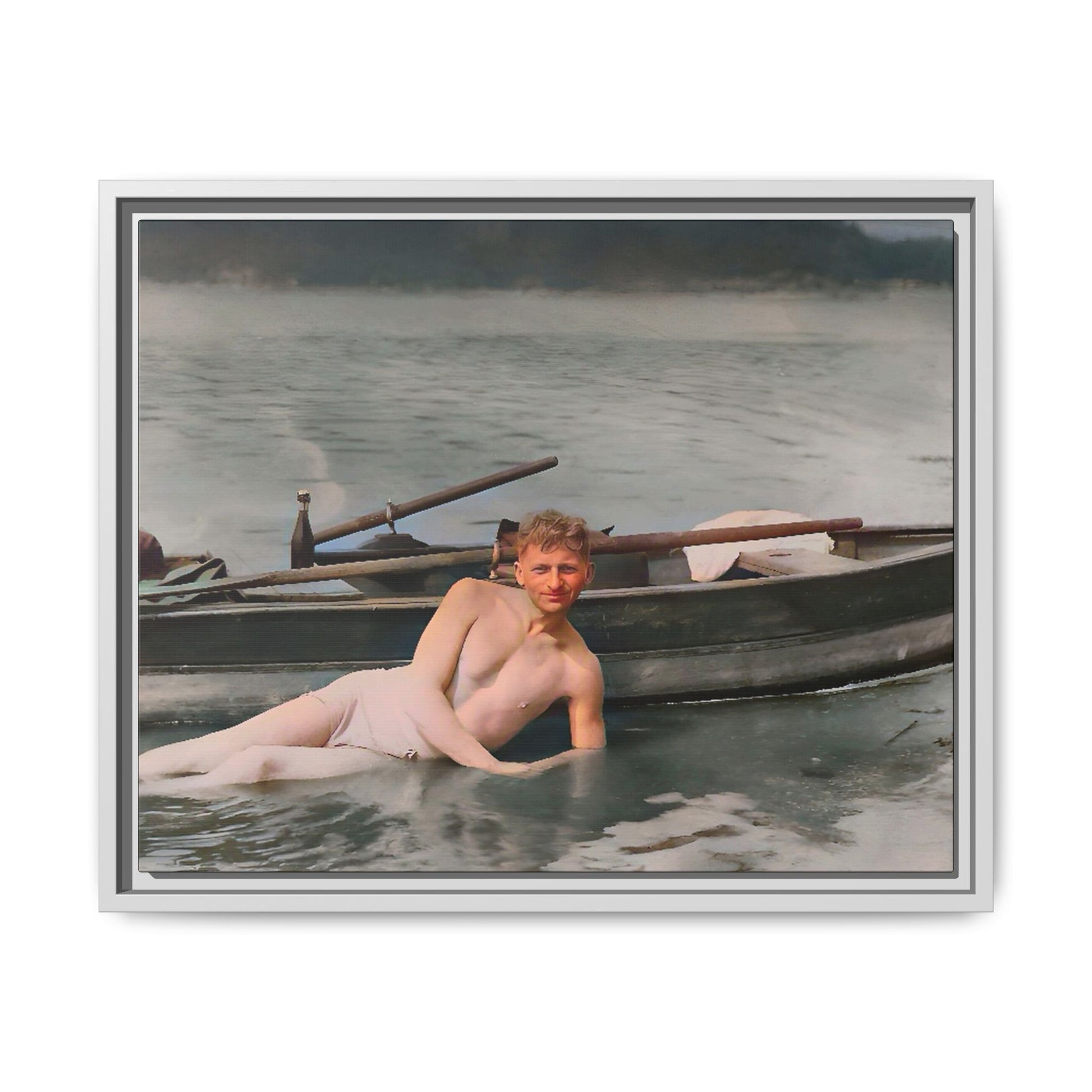 Restored vintage photo of Claude reclining by a rowboat on a calm lake in early 1900s Green Bay, Wisconsin. Framed matte canvas art celebrating serenity, history, and individuality.