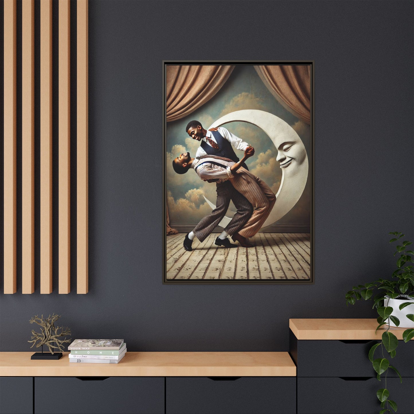Framed artwork of two Black men in vintage suits dancing tenderly beneath a crescent moon with a smiling face. A romantic 1920s-inspired scene with velvet curtains and a painted sky backdrop. Part of a collection reclaiming lost queer Black history and art.