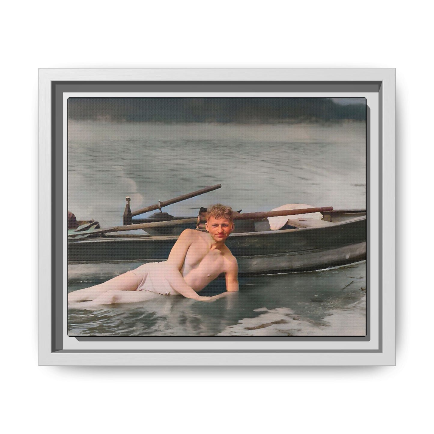 Restored vintage photo of Claude reclining by a rowboat on a calm lake in early 1900s Green Bay, Wisconsin. Framed matte canvas art celebrating serenity, history, and individuality.