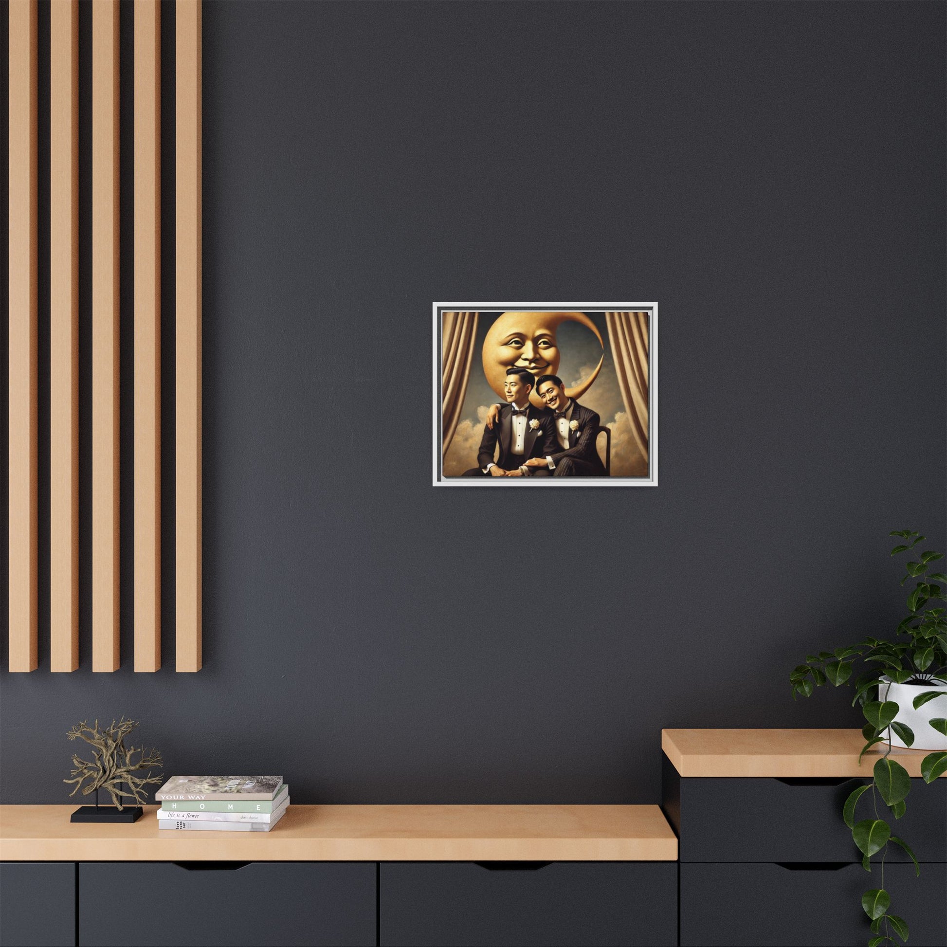 Vintage-inspired artwork of a romantic gay Asian couple in tuxedos sitting affectionately beneath a smiling crescent moon prop, surrounded by vintage stage curtains and dreamy clouds. A reclaimed queer narrative from the Man In The Moon series.