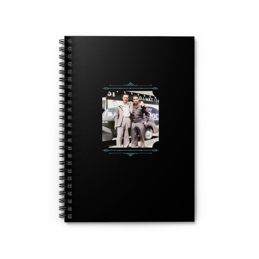 Notebook featuring a vintage WWII-era photo of a gay couple—soldier and civilian—outside a mechanic garage.