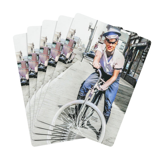 Vintage photo of a young man riding a bicycle through an early 20th-century city street, exuding confidence and freedom.