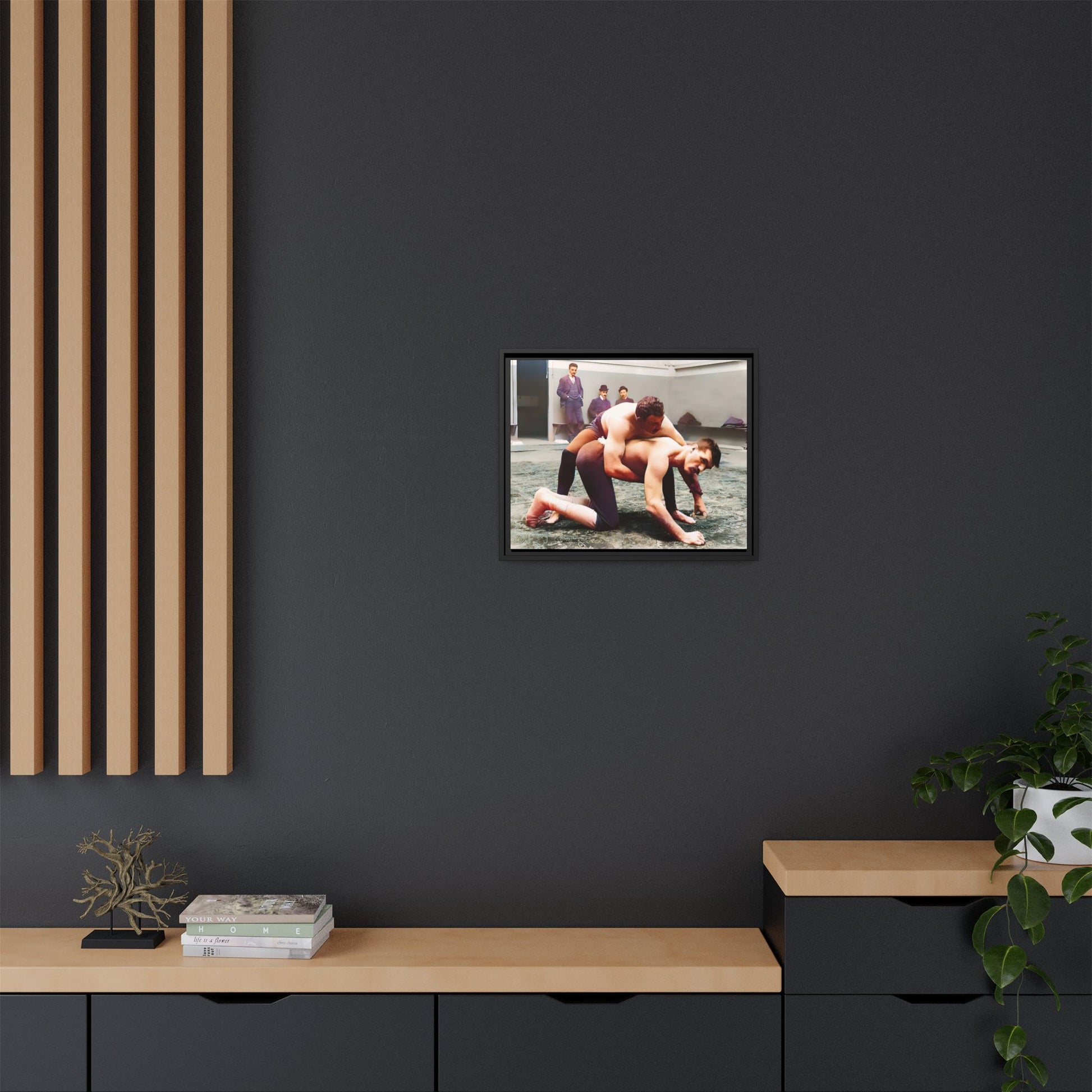 A framed vintage wrestling photograph on matte canvas featuring a Victorian-era match at Love’s Wrestling Club in Plumstead, UK, capturing strength and camaraderie.