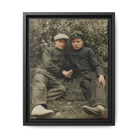Vintage outdoor portrait of two companions in military-style uniforms seated on grass