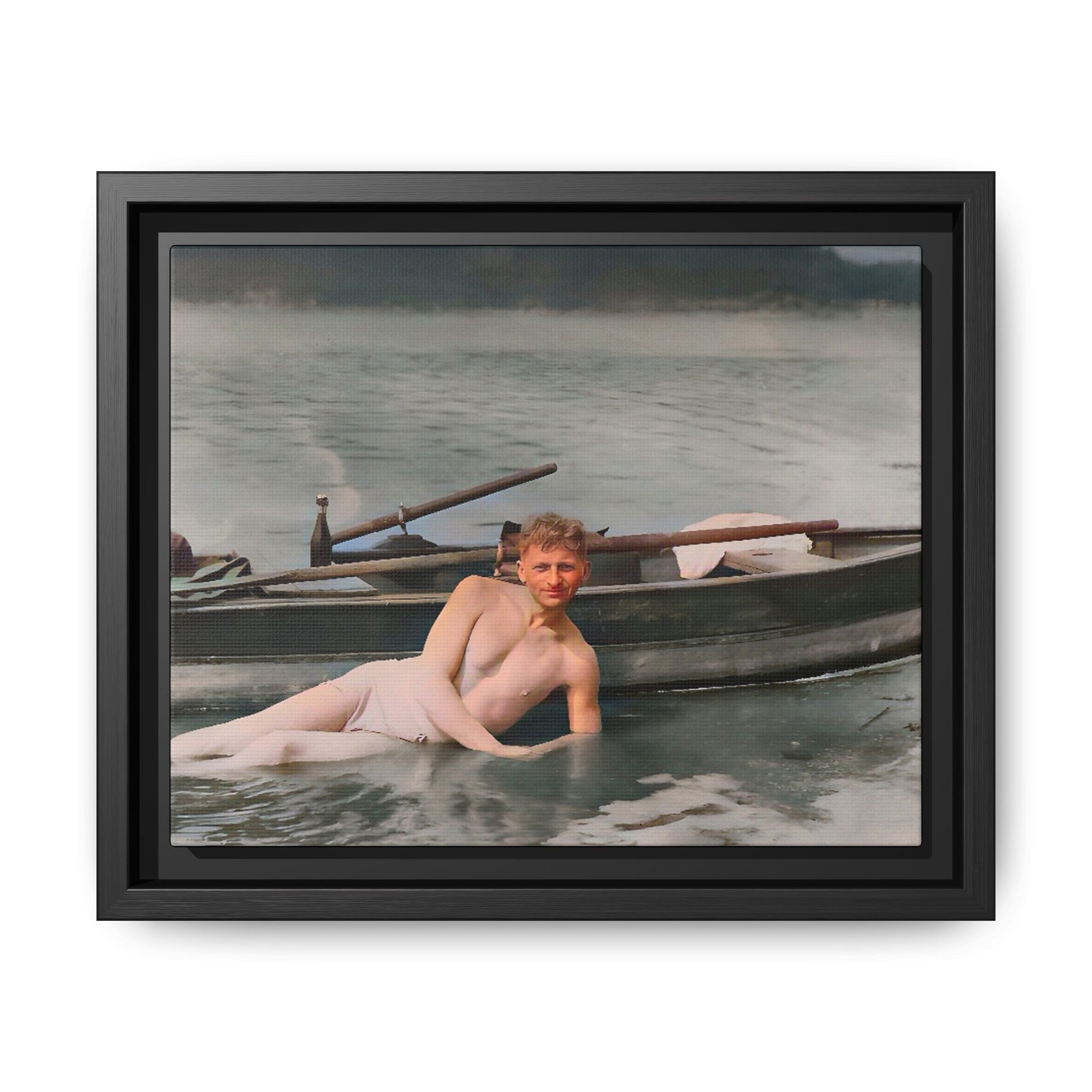 Restored vintage photo of Claude reclining by a rowboat on a calm lake in early 1900s Green Bay, Wisconsin. Framed matte canvas art celebrating serenity, history, and individuality.