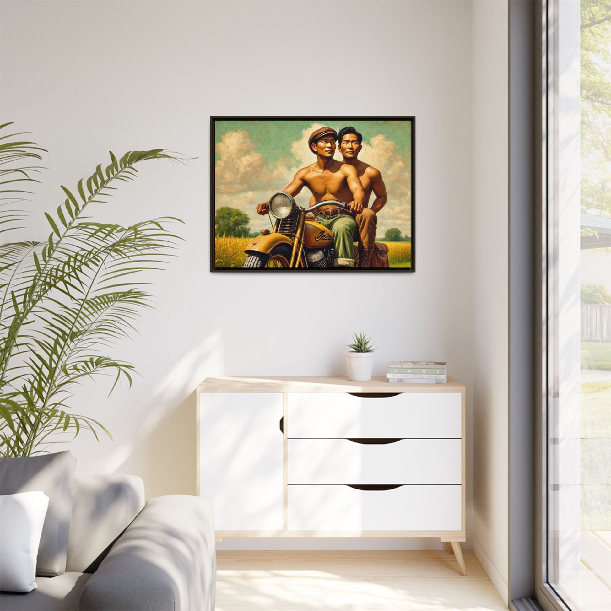 Framed artwork of an Asian-American gay couple riding a vintage yellow motorcycle through Iowa's serene countryside, celebrating love and unity.
