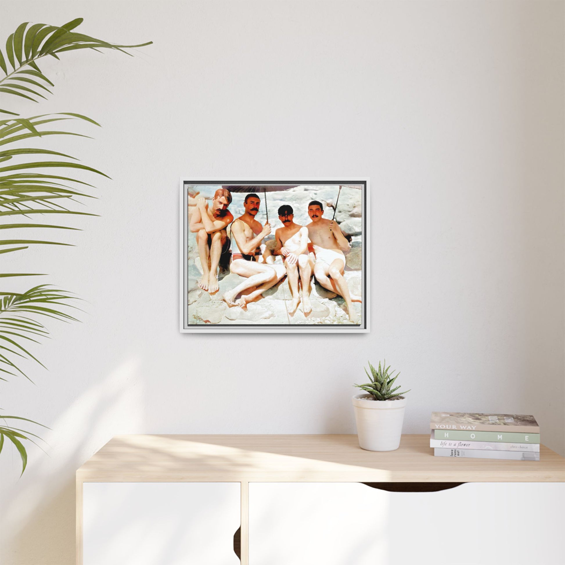 A nostalgic vintage beach photograph from Herring Cove Beach, Provincetown, MA. This framed canvas print captures four men in a relaxed summer moment, perfect for coastal home decor or as an LGBTQ+ history tribute.