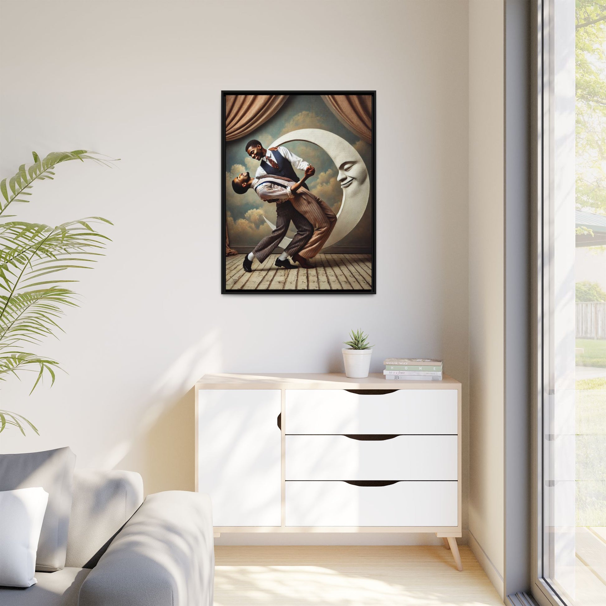 Framed artwork of two Black men in vintage suits dancing tenderly beneath a crescent moon with a smiling face. A romantic 1920s-inspired scene with velvet curtains and a painted sky backdrop. Part of a collection reclaiming lost queer Black history and art.
