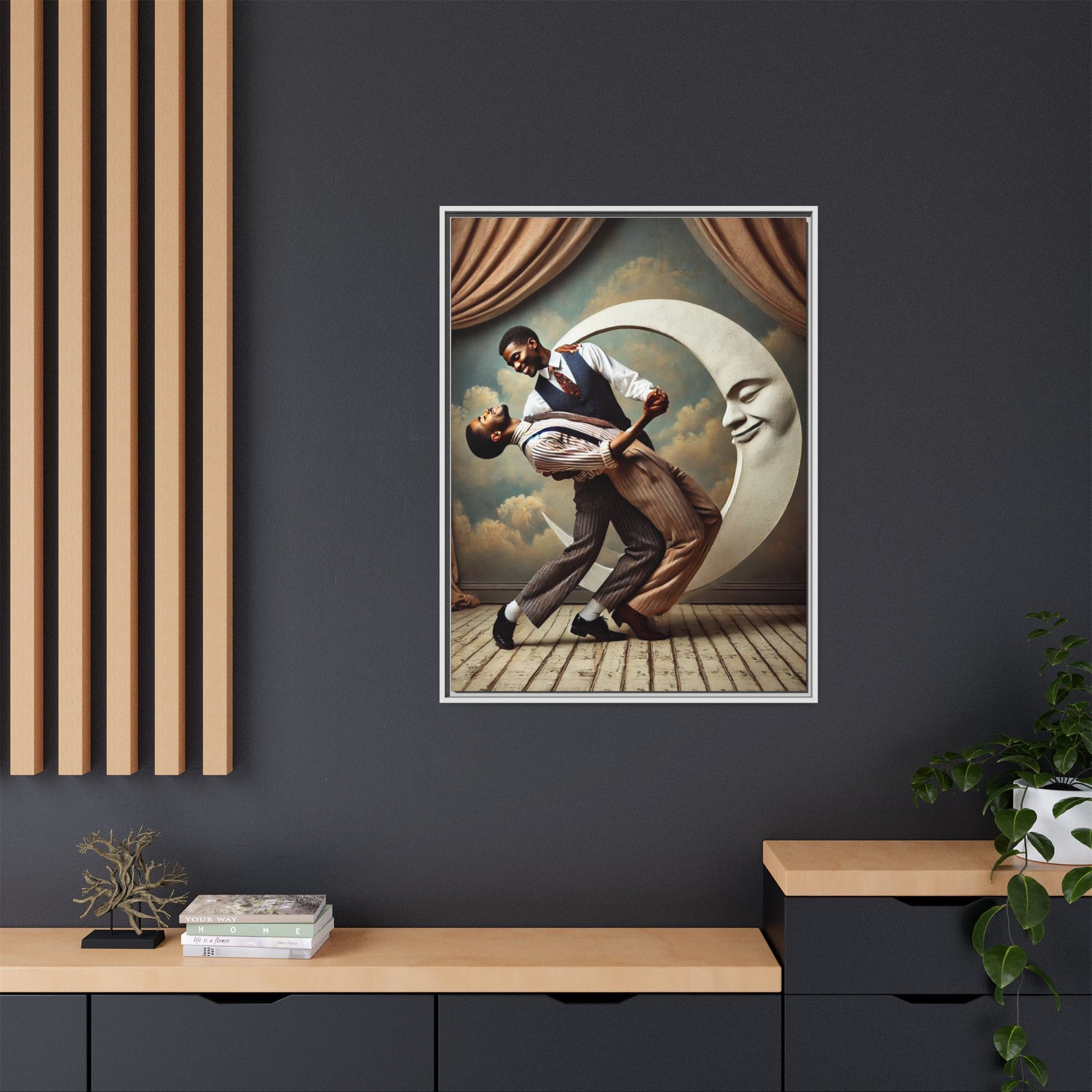 Framed artwork of two Black men in vintage suits dancing tenderly beneath a crescent moon with a smiling face. A romantic 1920s-inspired scene with velvet curtains and a painted sky backdrop. Part of a collection reclaiming lost queer Black history and art.