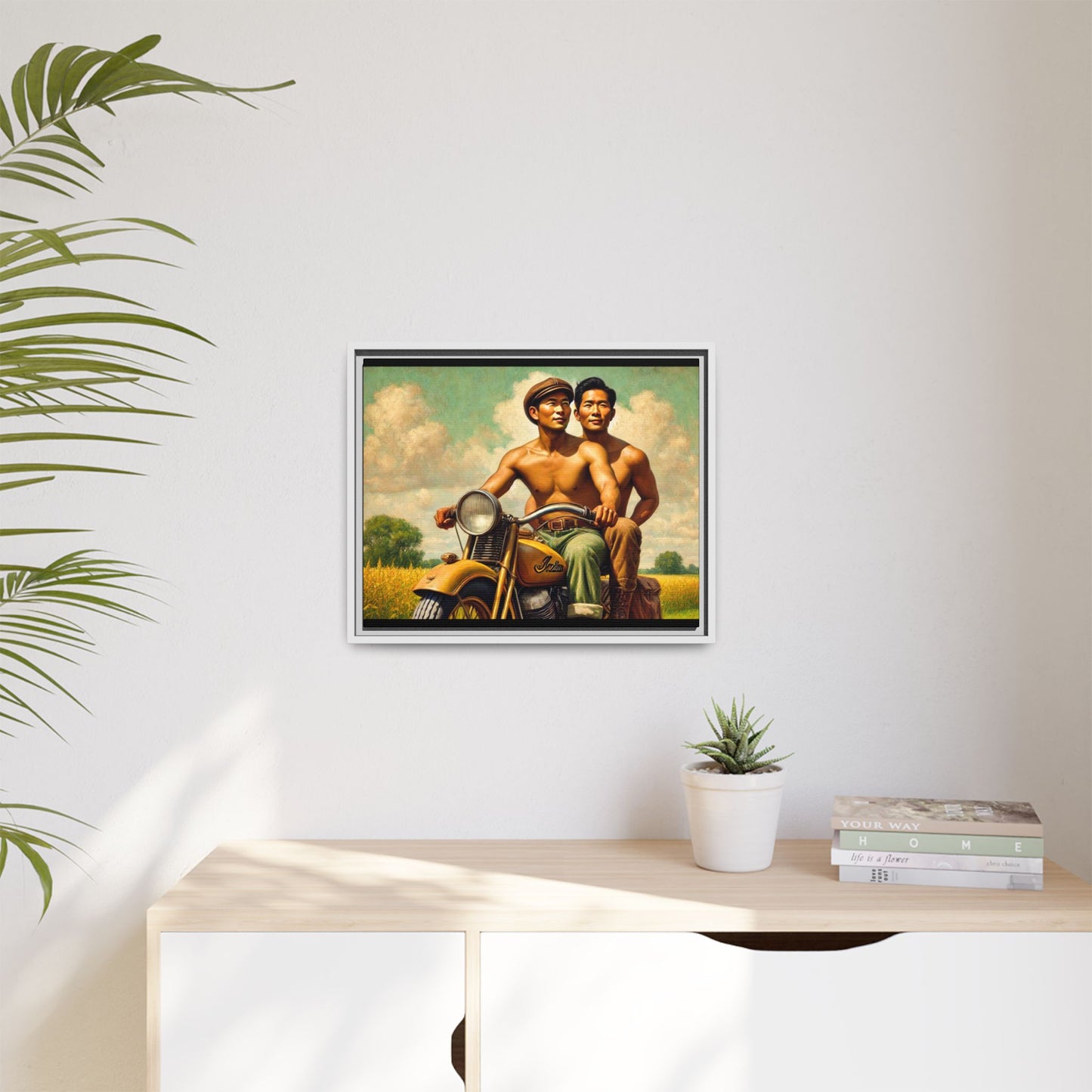 Framed artwork of an Asian-American gay couple riding a vintage yellow motorcycle through Iowa's serene countryside, celebrating love and unity.