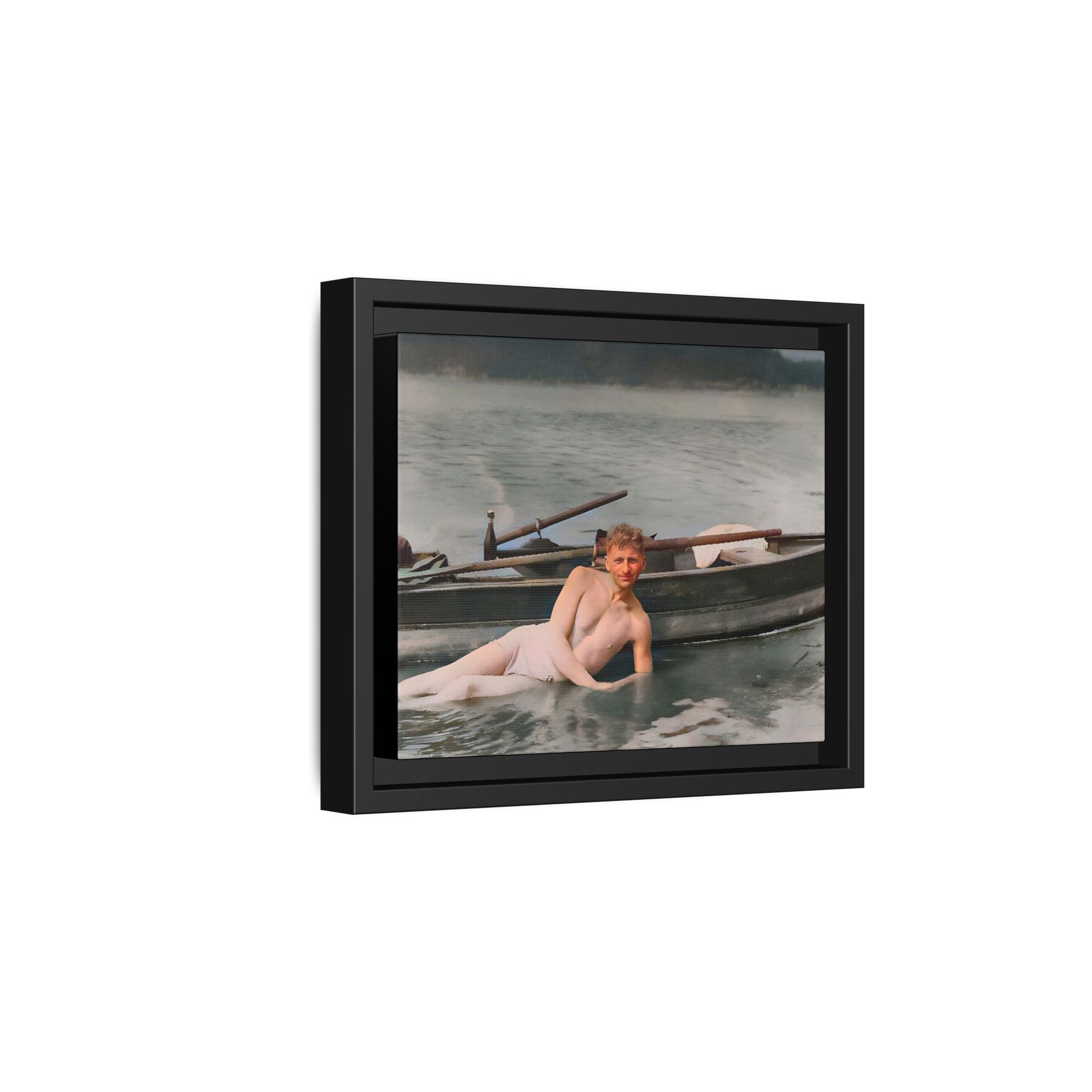 Restored vintage photo of Claude reclining by a rowboat on a calm lake in early 1900s Green Bay, Wisconsin. Framed matte canvas art celebrating serenity, history, and individuality.
