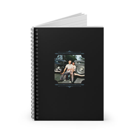 Colorized mid-century gay couple standing close in front of classic cars, featured on a black spiral notebook cover