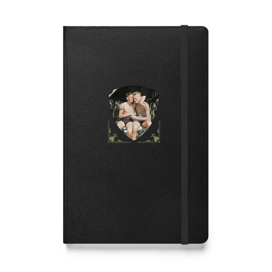 A black hardcover journal featuring a vintage photo of a shirtless gay couple enjoying a summer embrace.