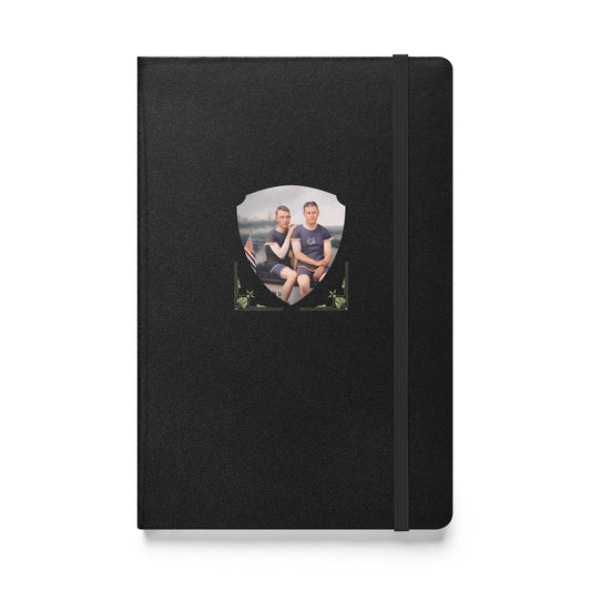 Black hardcover journal featuring a vintage photo of two men seated by a lake with an American flag.