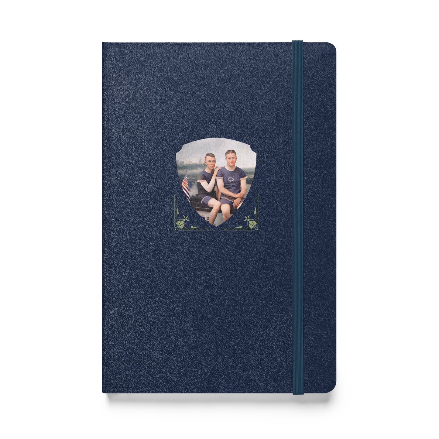 Notebook with vintage gay couple in matching navy athletic wear sitting beside a lake with a US flag in view.