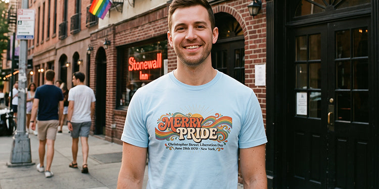 Man wearing Walt & Pete® Merry Pride 1970 Christopher Street Liberation Day LGBTQ history shirt outside the Stonewall Inn in New York City.