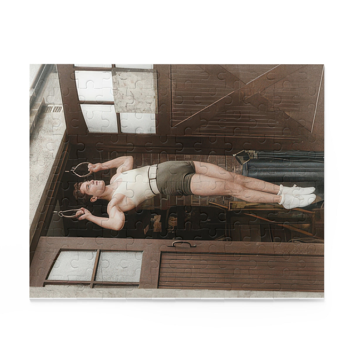Vintage athlete puzzle being assembled, showing the pale shirt, suspended handles, and dark wooden doorway.