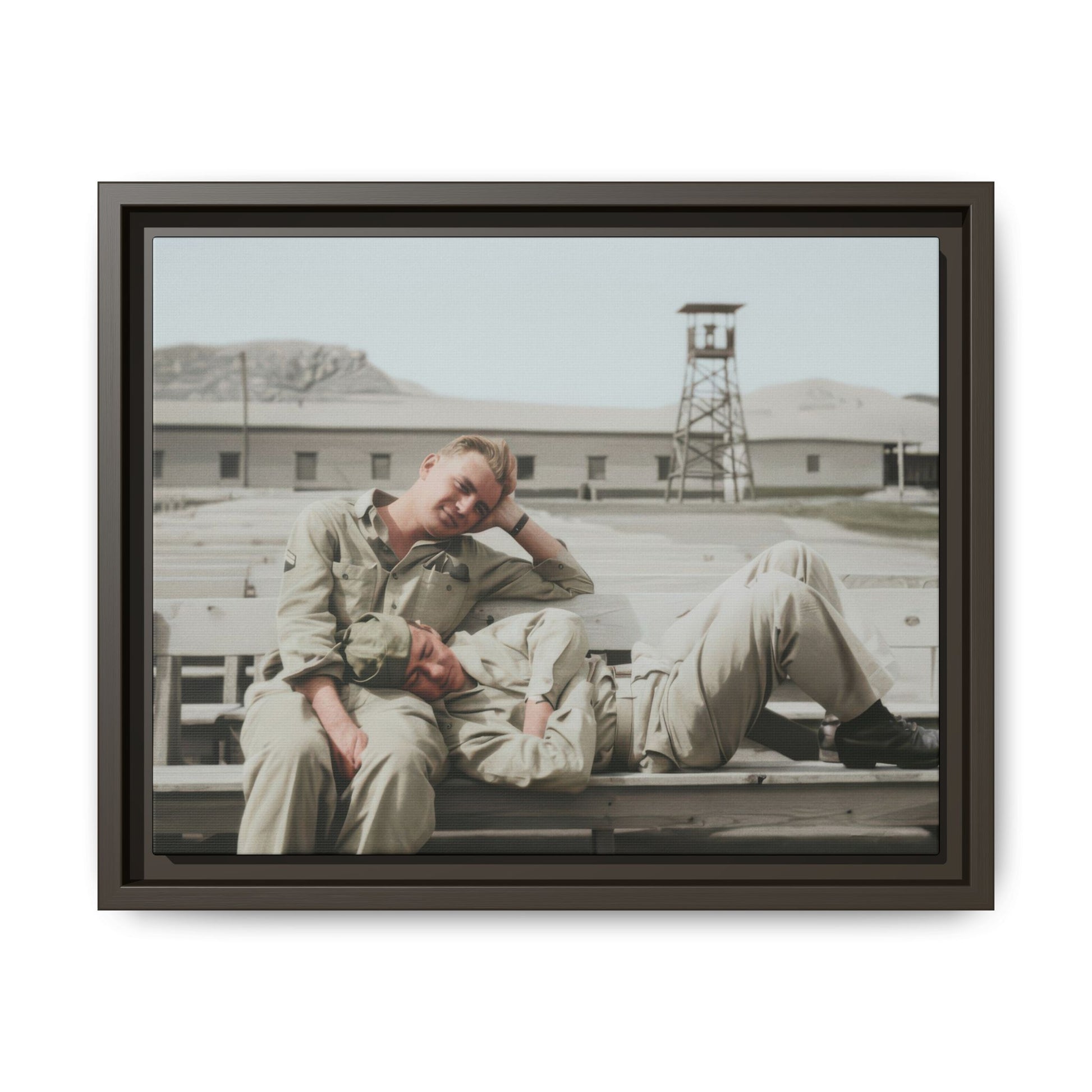 Mid-century outdoor portrait of two soldiers seated and reclining together on benches at a military compound