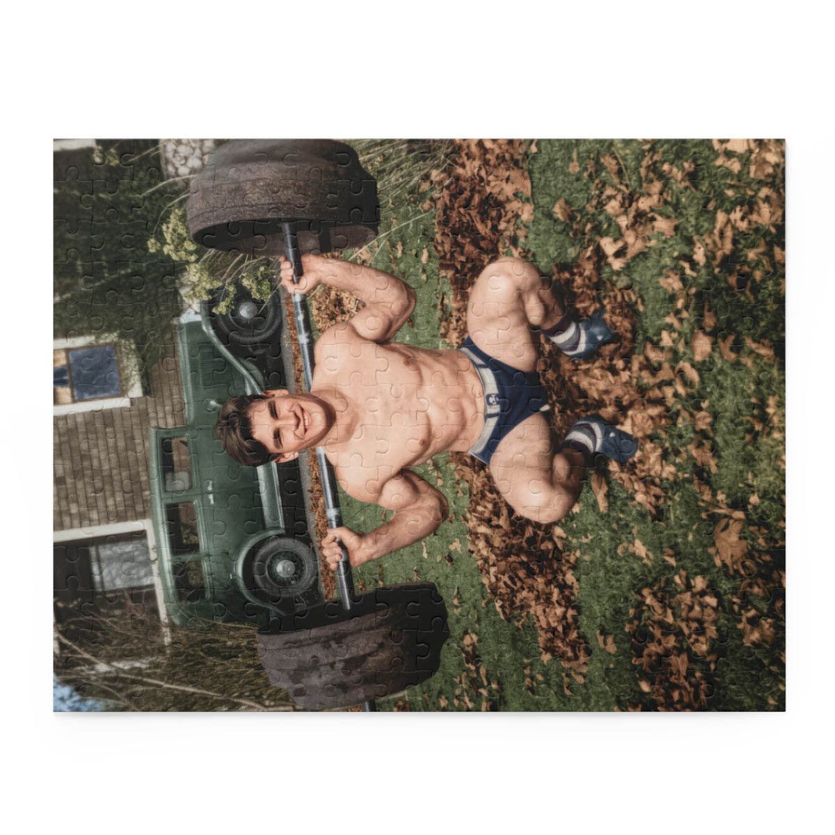 Close-up of the vintage squat puzzle showing a dark barbell plate, striped socks, and leaf-covered grass.