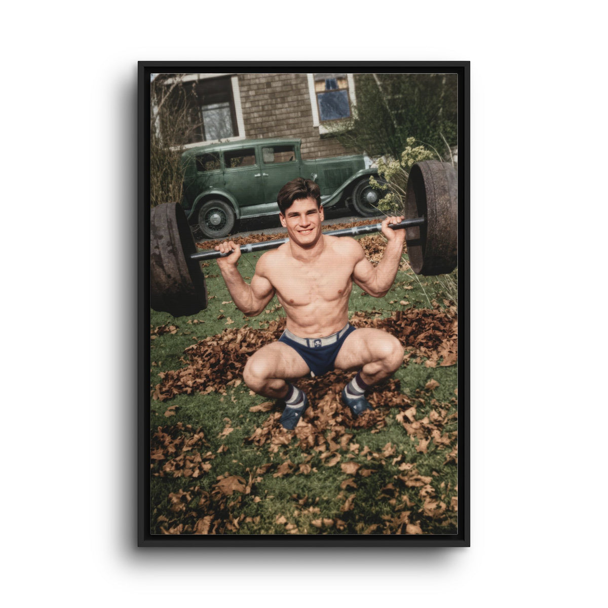 Unidentified athlete squatting with a plate-loaded barbell on a leaf-covered lawn circa 1928 to 1935 