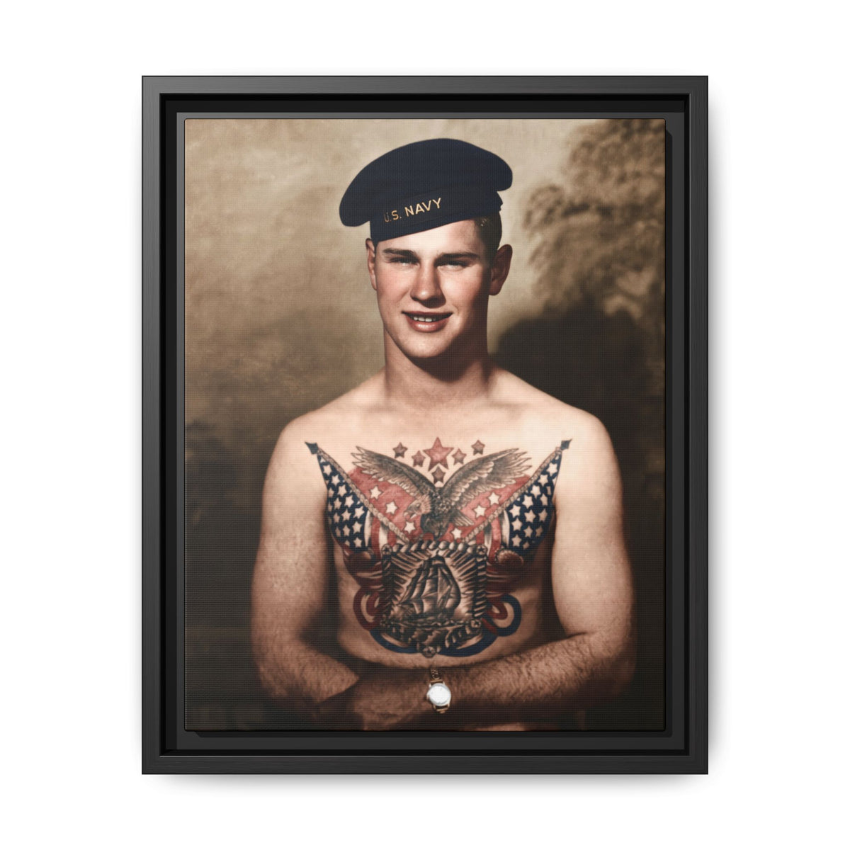 Restored portrait of a sailor wearing a U.S. Navy cap, with crossed forearms beneath a large eagle chest tattoo.