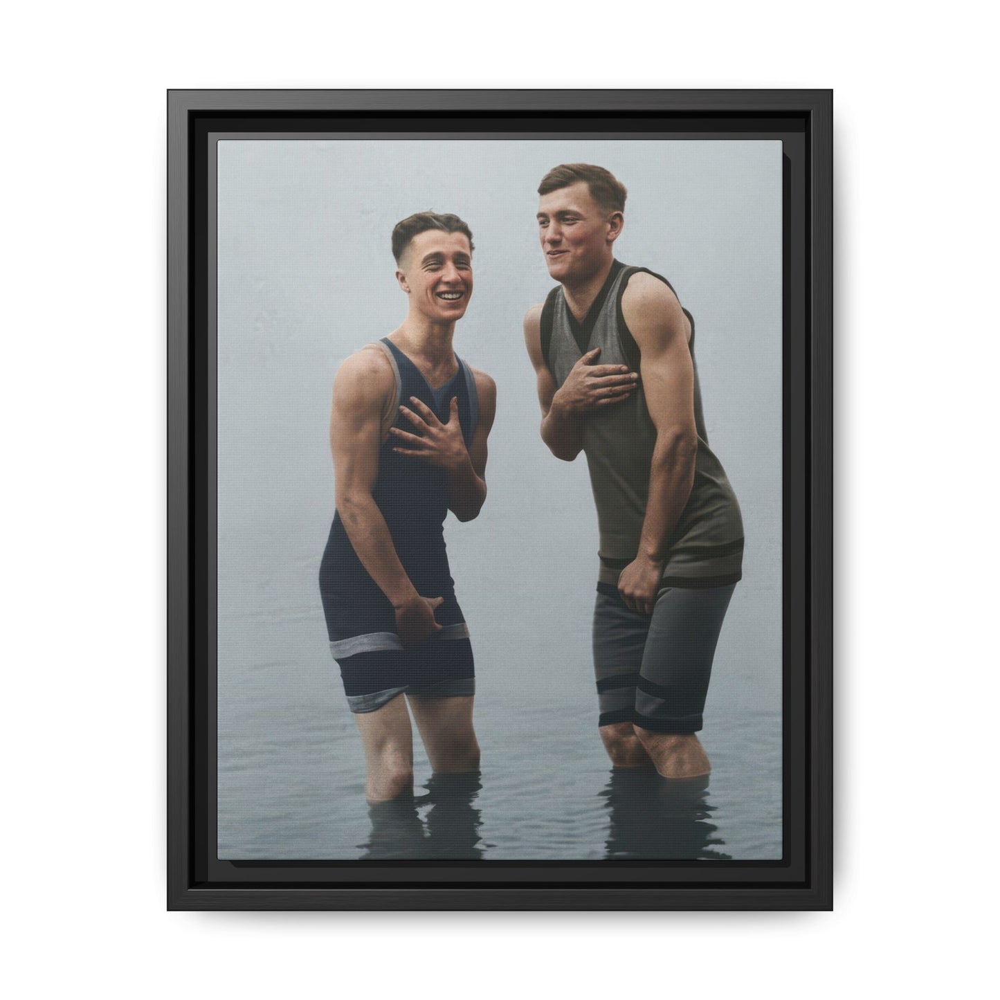 Restored vintage photograph of two men standing in shallow water in period bathing suits 