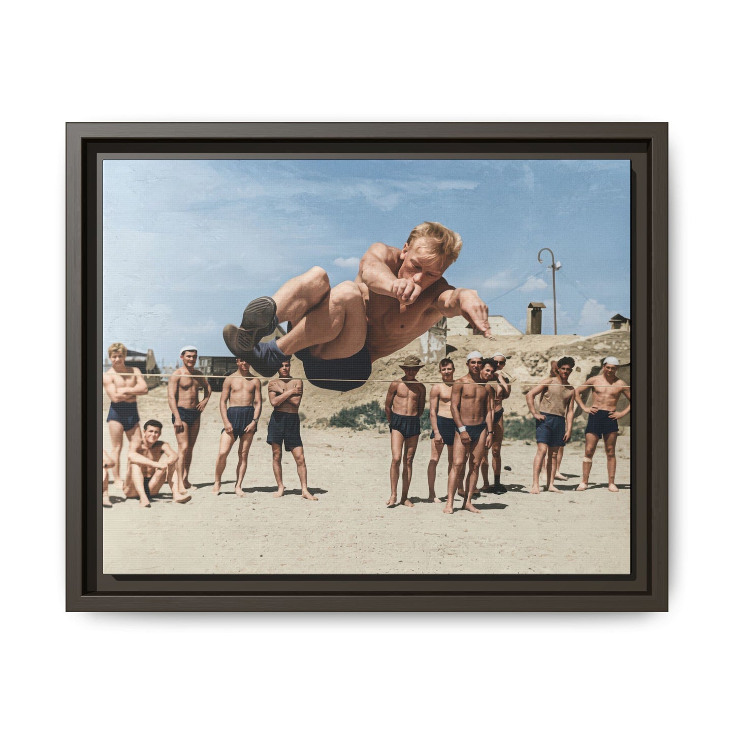Historical action photograph canvas print with group of men in bathing trunks on sand 