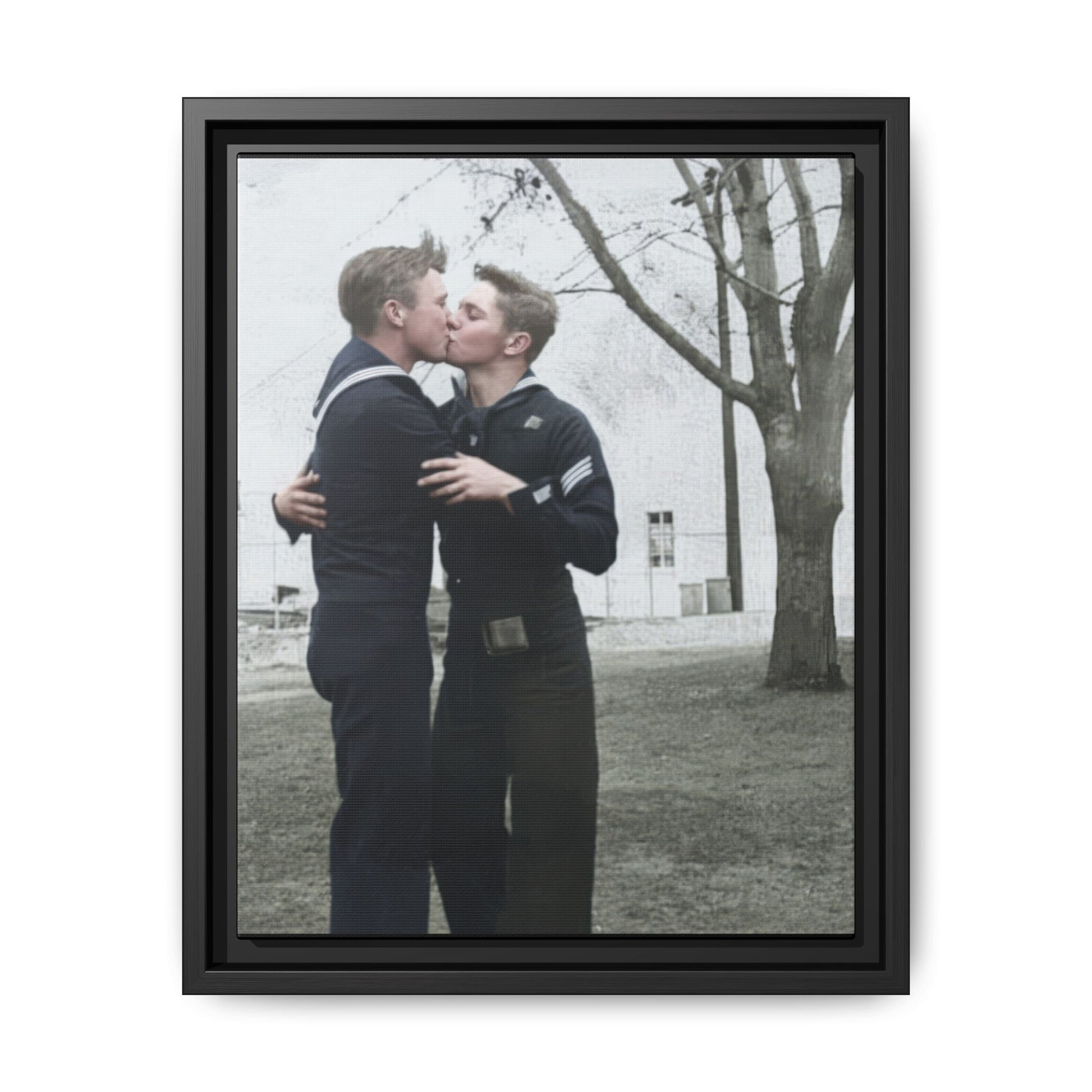 Mid-20th century outdoor photograph of two sailors in dark naval uniforms standing closely together