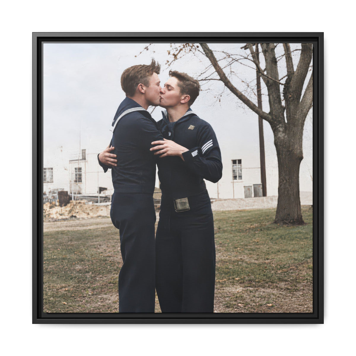 Historical image of two sailors embracing beneath a leafless tree with a pale building in the background.