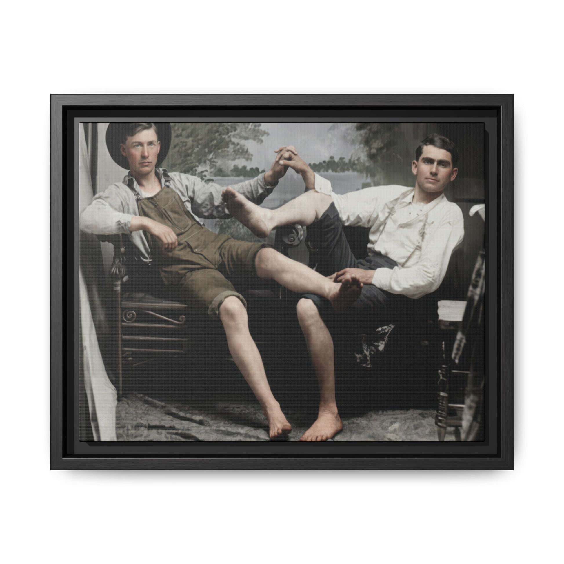 Vintage studio photograph of two seated companions with crossed legs and joined hands