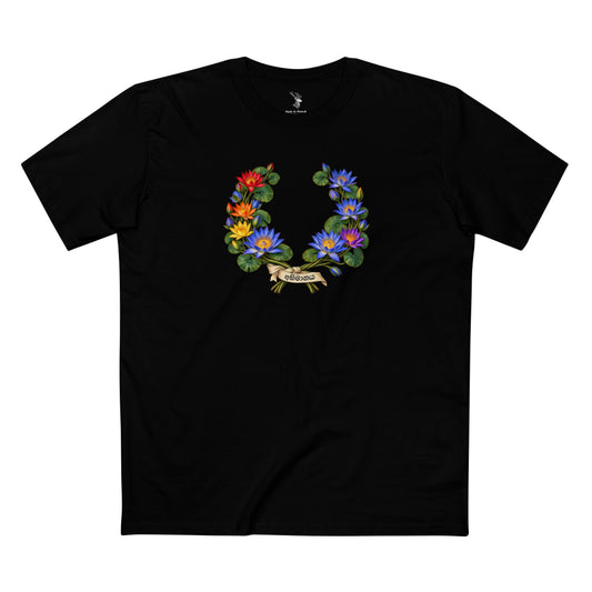 Open wreath of blue water lilies with red, orange, yellow, and violet flowers, green leaves, and an ivory ribbon bearing අභිමානය in charcoal lettering.