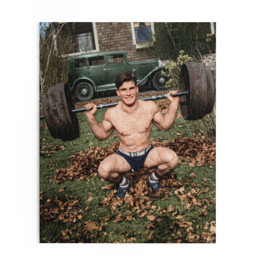 Artwork for a vintage weightlifting jigsaw puzzle showing a smiling athlete in a deep barbell squat on a leaf-covered lawn, with a sedan and shingled building behind him.