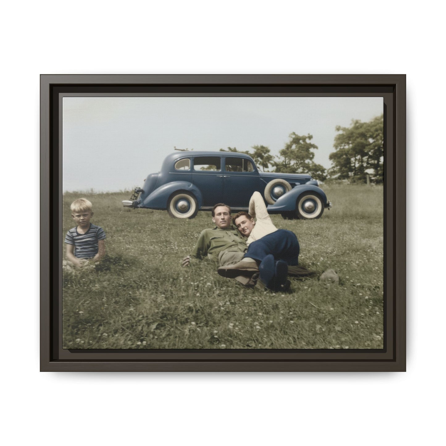 Vintage snapshot of two men relaxing in field with classic car in background