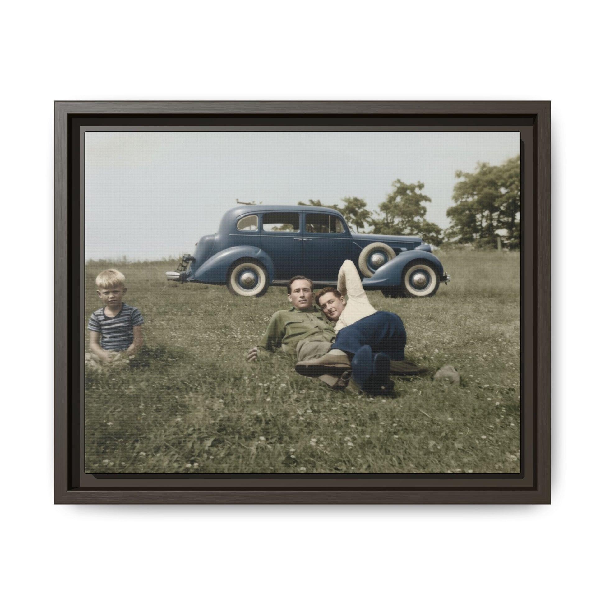 Vintage snapshot of two men relaxing in field with classic car in background