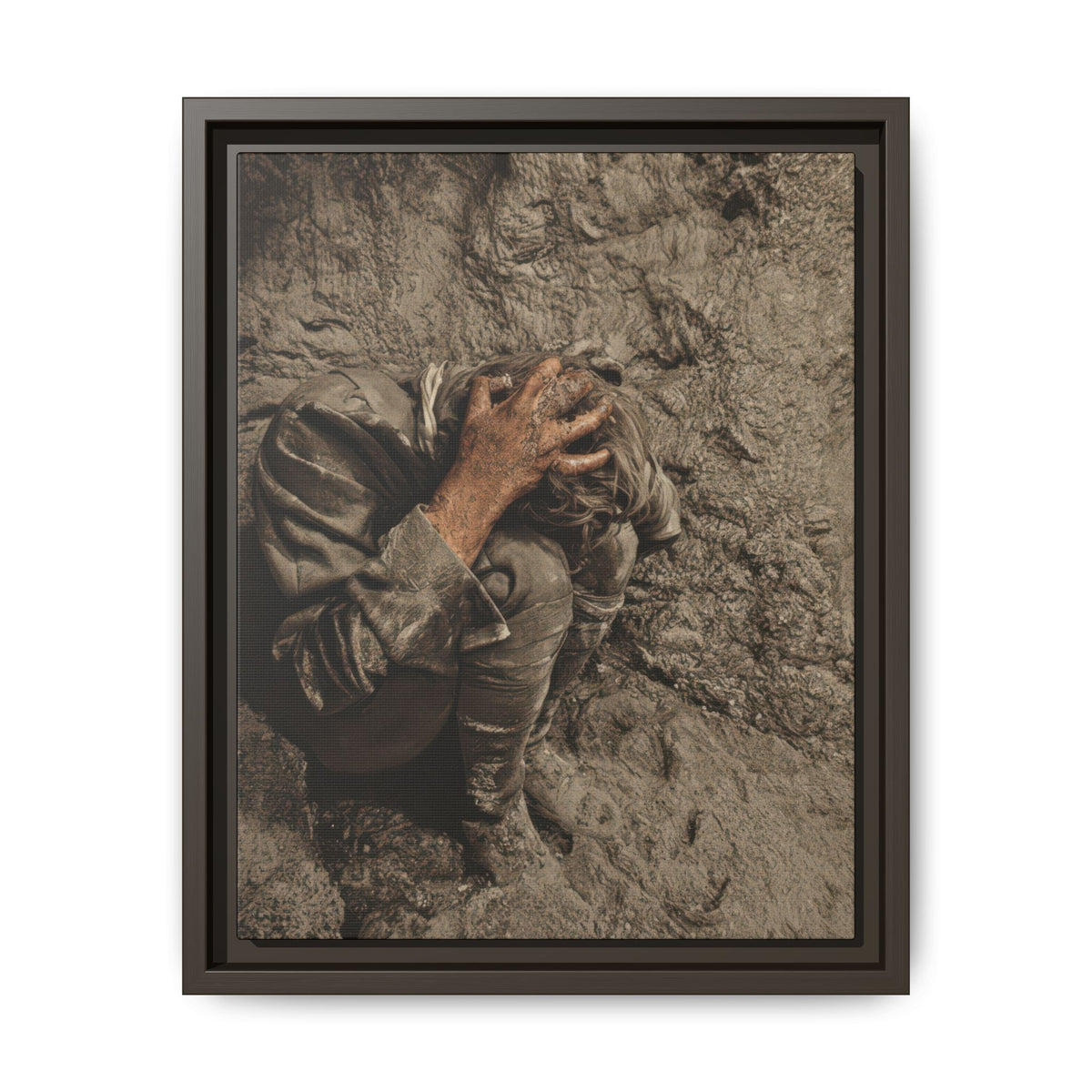 Crouched figure with knees drawn close and face concealed, wearing loose clothing amid textured earth in muted brown and gray tones.