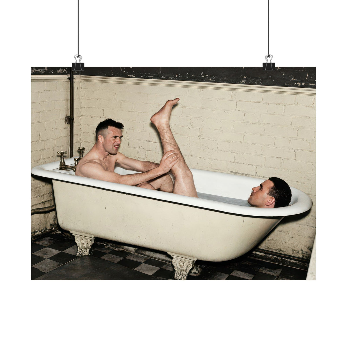 Restored bathing photograph showing ornate bathtub feet, brass-colored taps, exposed pipes, and black-and-white floor tiles.