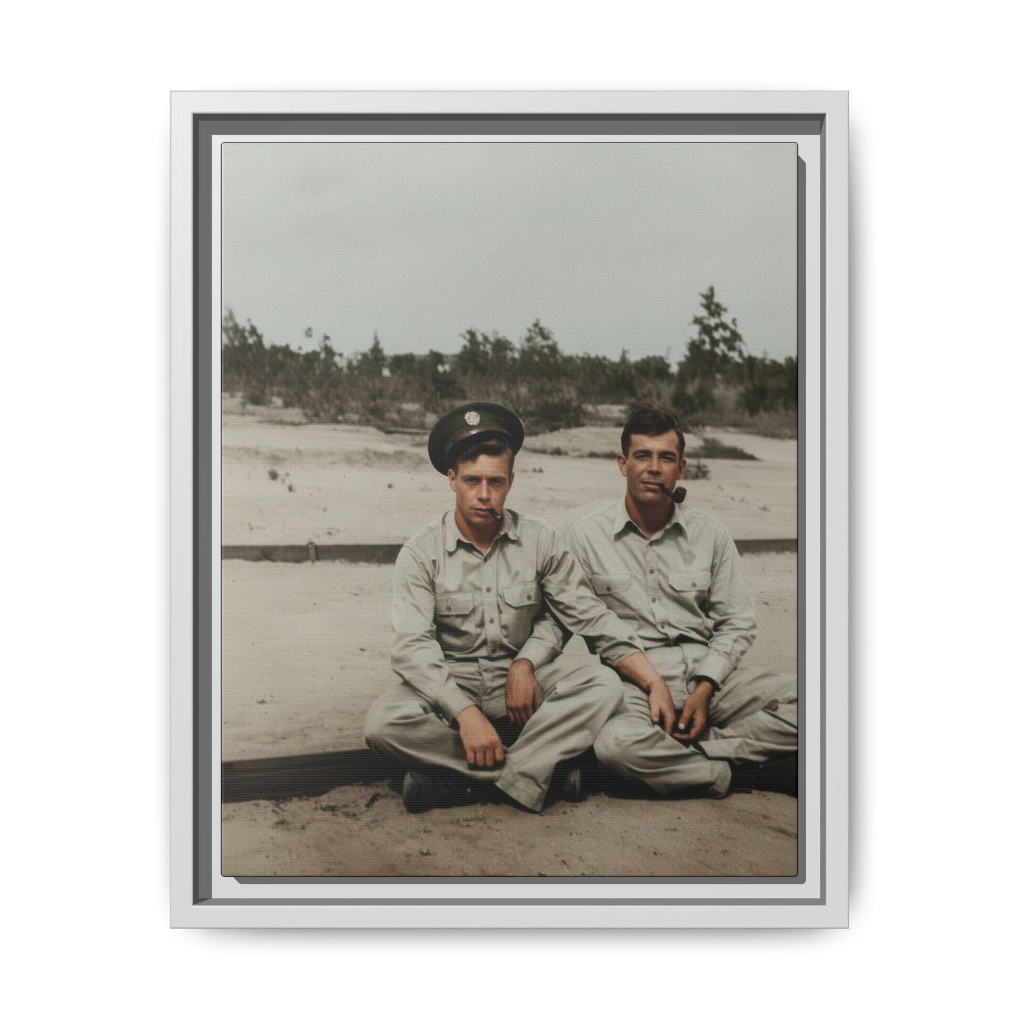 Mid-century outdoor paired portrait of two men seated on the ground in a sparse landscape setting