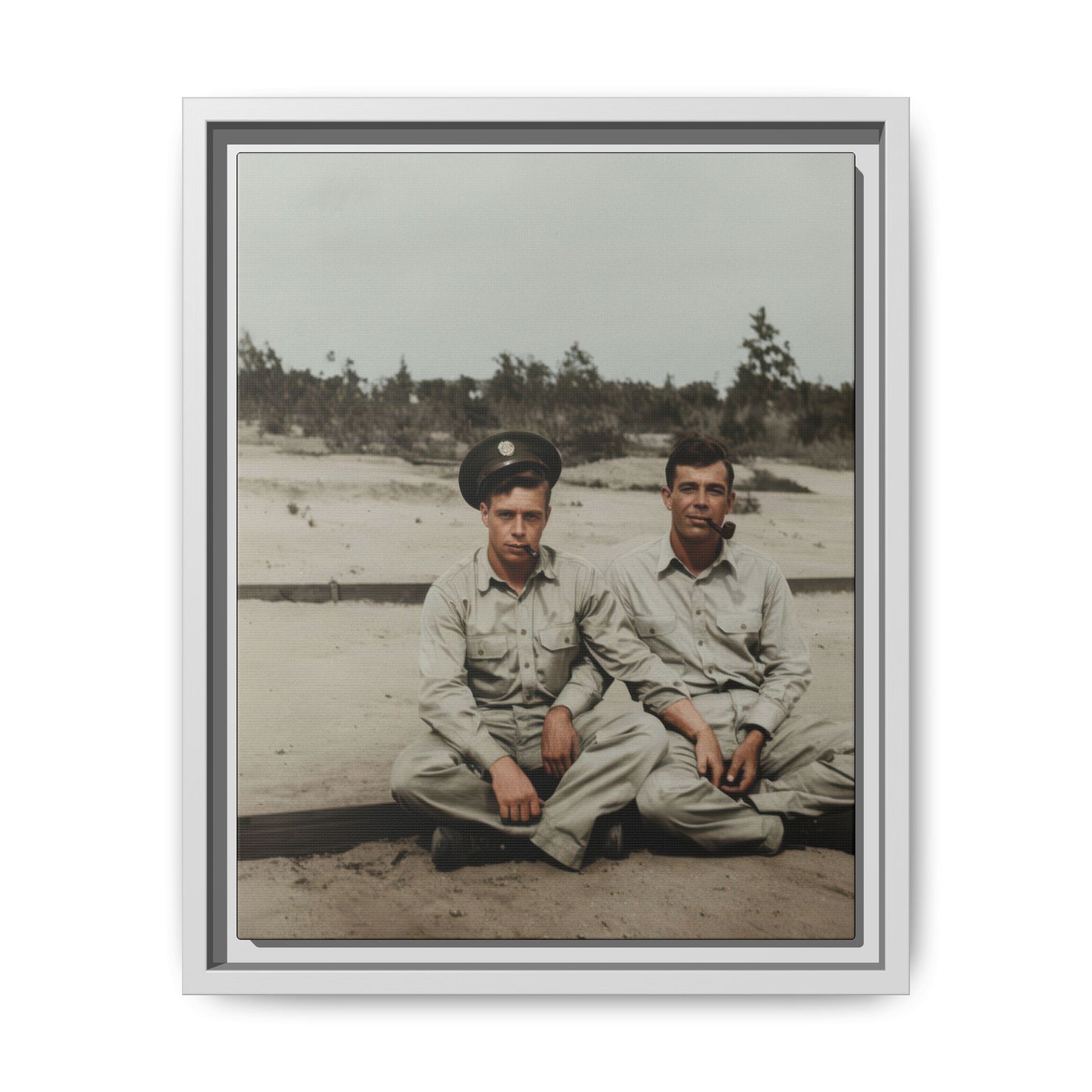 Mid-century outdoor paired portrait of two men seated on the ground in a sparse landscape setting