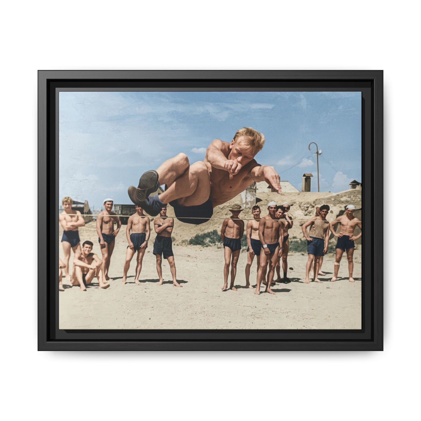 Vintage airborne jumper photograph reproduced as framed canvas wall art with spectators on sandy ground 
